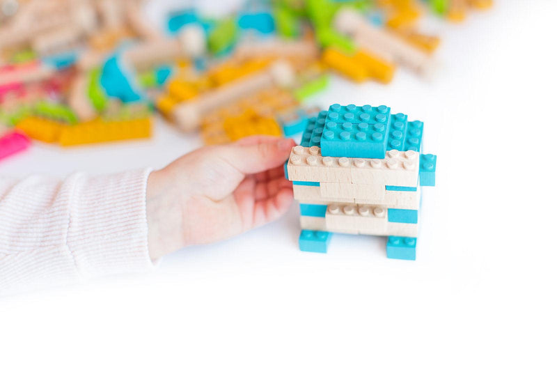 Once Kids Eco-Bricks™ Color made with water based color and biodegradable wooden construction blocks. The Eco-Bricks™ Color 54-piece set is made from Non-Toxic Water-Base Color, a brilliant first step into healthier, greener, construction block fun! Building Construction toy